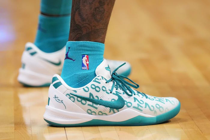Charlotte Hornets guard Terry Rozier's white and teal Nike Kobe sneakers.